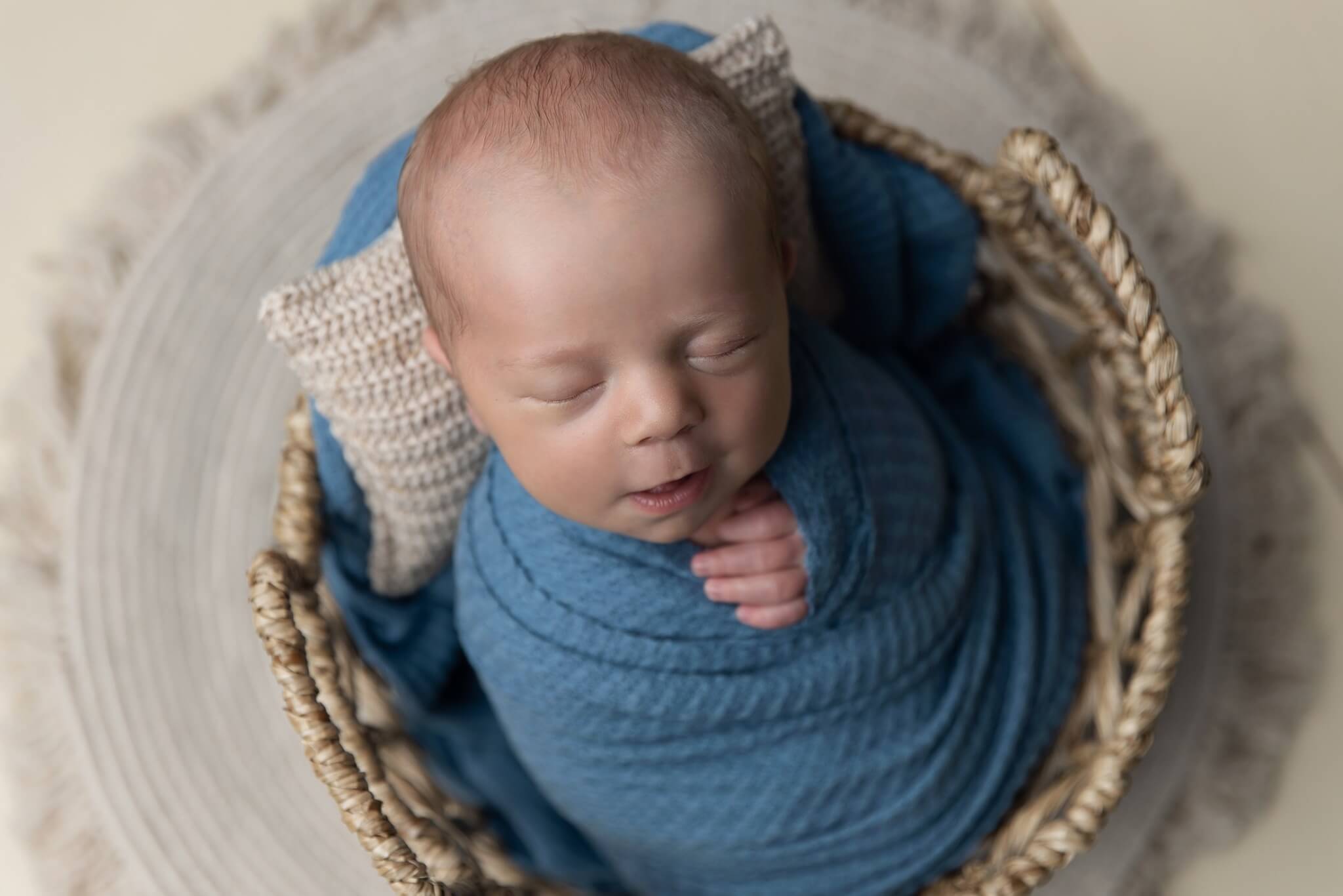 Photo of baby swaddled in basket